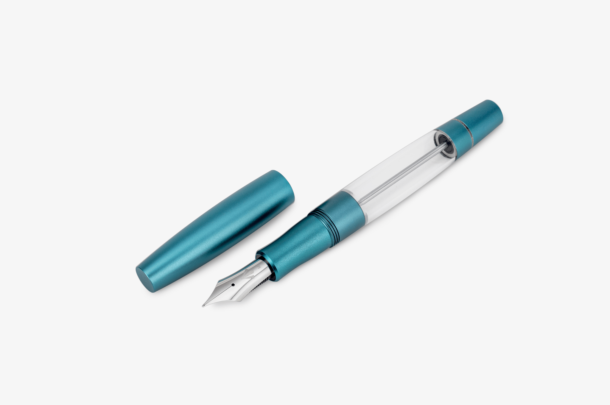Gravitas Monster Aluminum fountain pen in color Teal and clear body, holding a massive amount of ink, with 7ml fully filled.